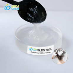 Close-up of SLES (Sodium Laureth Sulfate) liquid surfactant on transparent dish with spoon demonstrating viscosity and texture