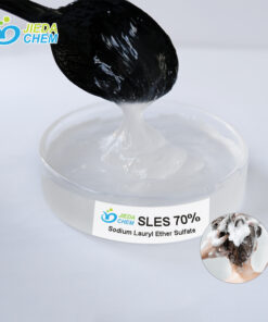 Close-up of SLES (Sodium Laureth Sulfate) liquid surfactant on transparent dish with spoon demonstrating viscosity and texture