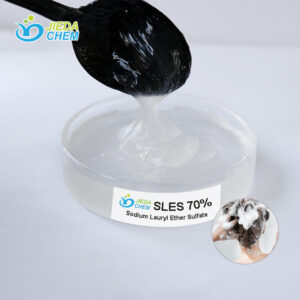 Close-up of SLES (Sodium Laureth Sulfate) liquid surfactant on transparent dish with spoon demonstrating viscosity and texture