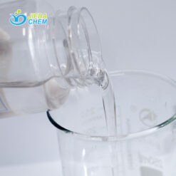 The transparent liquid Pentaerythrityl Tetraethylhexanoate contained in the small bottle is being poured into the beaker