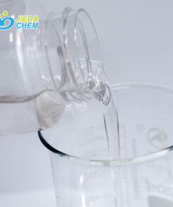The transparent liquid Pentaerythrityl Tetraethylhexanoate contained in the small bottle is being poured into the beaker