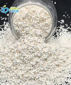 White crystalline Potassium Sorbate granules pouring from a glass bottle