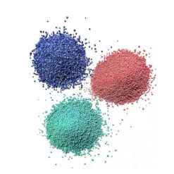 Color speckles of blue, green and red colors placed on white paper