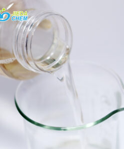 The transparent liquid Sodium lauroyl sarcosinate in the small bottle is poured into the beaker