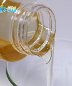 The yellow liquid Olive Oil Peg-8 Esters contained in the small bottle is being poured into the beaker